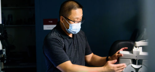 doctor gary chu discusses how to use exam equipment in darkly lit classroom