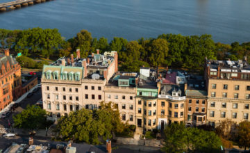 Aerial view of Beacon St campus with Charles River in background.